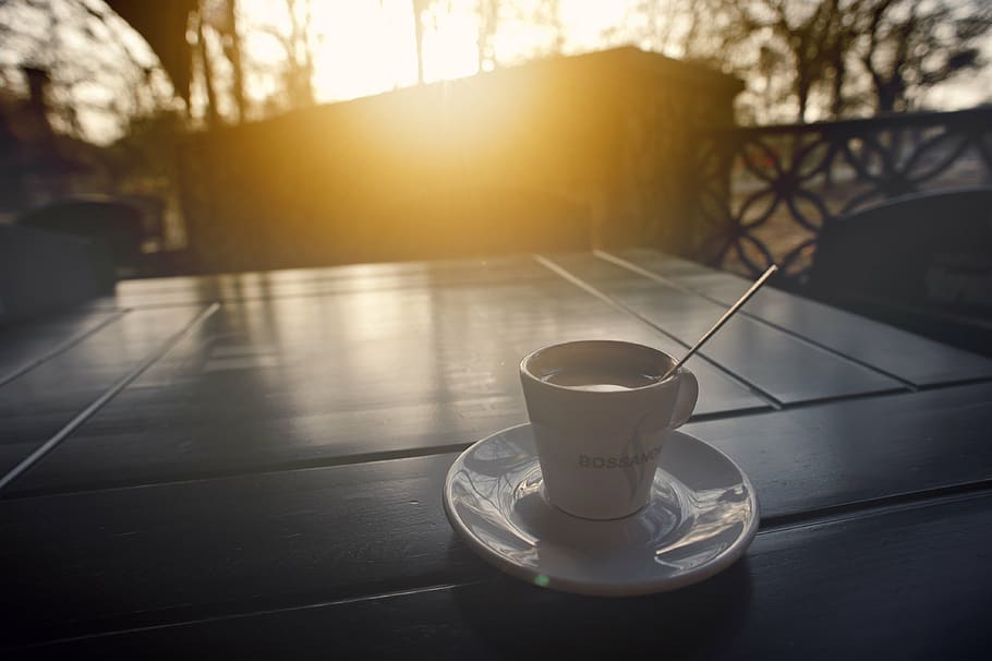 full-filled, white, ceramic, cup, coffee, saucer, table, sunset, trees, terrace