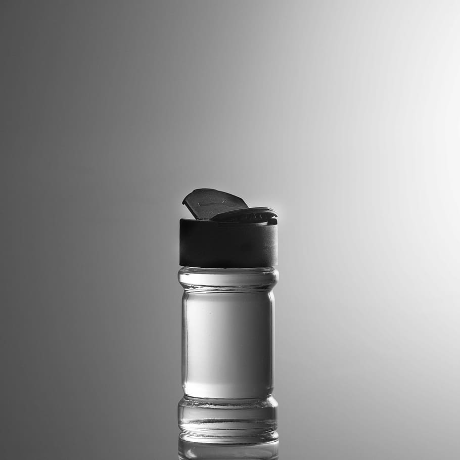 clear, black, tumbler, filled, water, spreader, spice shakers, pepper shaker, studio shot, single object