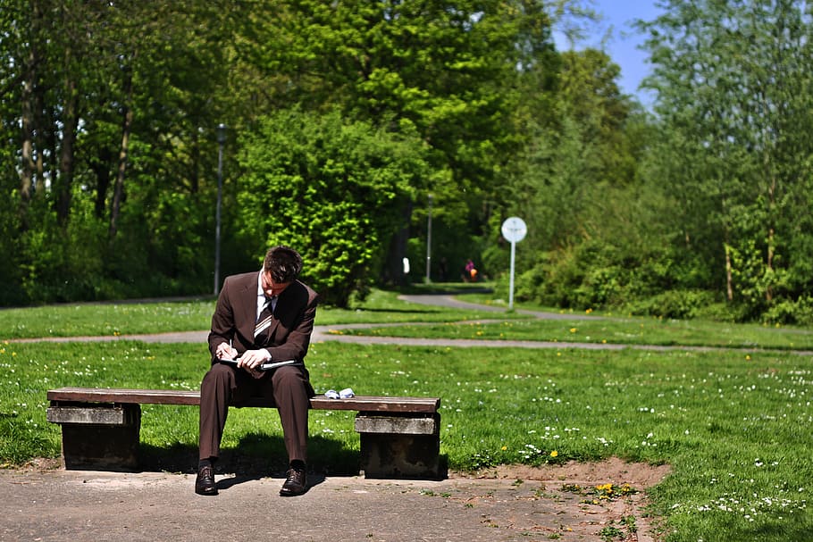 man, wearing, black, suit jacket, sitting, brown, concrete, bench, business, corporate