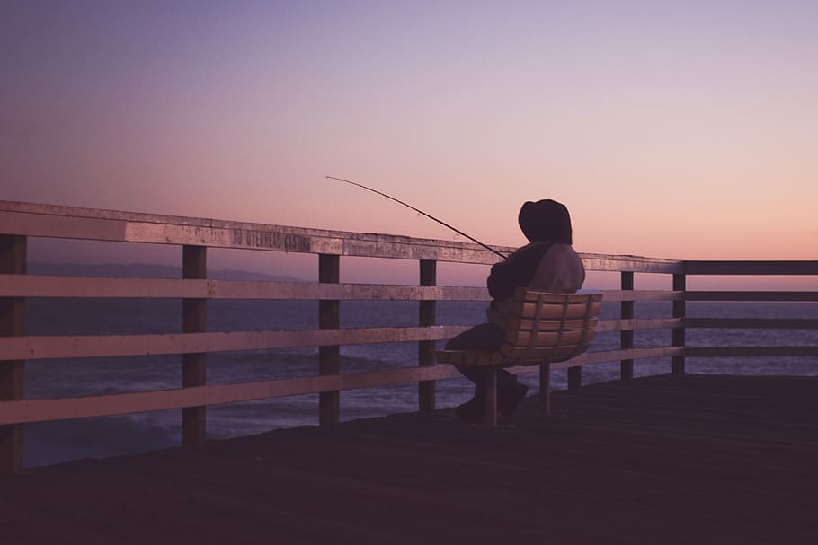 person, sitting, bench, holding, fishing rod, hooded, jacket, fishing, twilight, people