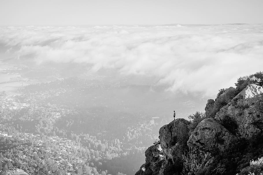 person, standing, top, cliff, nature, mountain, clouds, rocks, city, monochrome