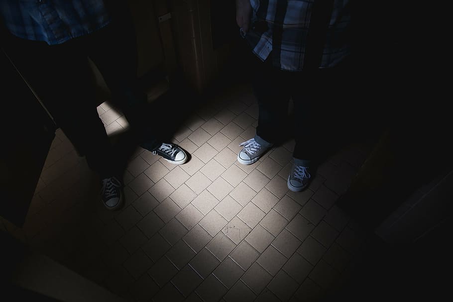two, person, standing, gray, tile flooring, pairs, black, converse, low, top