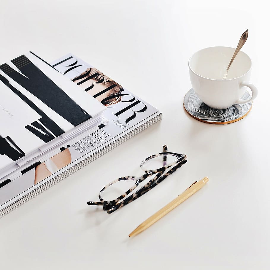 black, white, framed, eyeglasses, magazine, ceramic, mug, books, pen, coffee