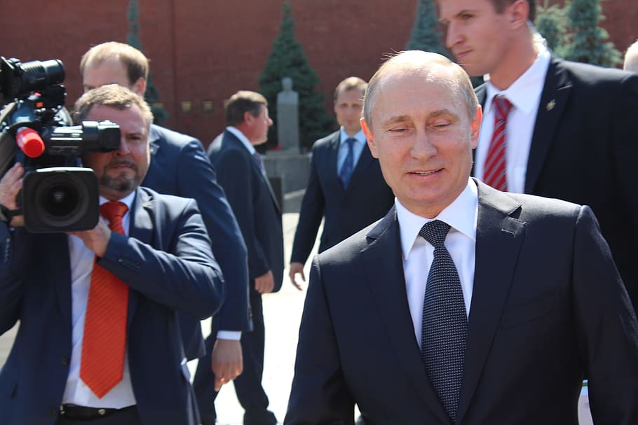 man, wearing, black, notched, lapel suit, holding, video camera, putin, the president of the, camera