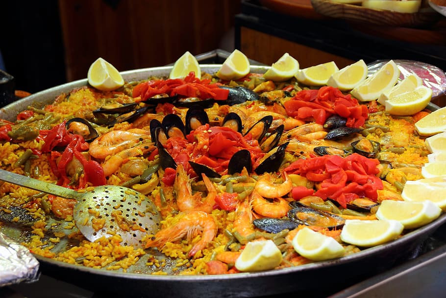 seafood paella dish, paella, rice, scampi, lemons, spain, national dish, eat, shrimp, food