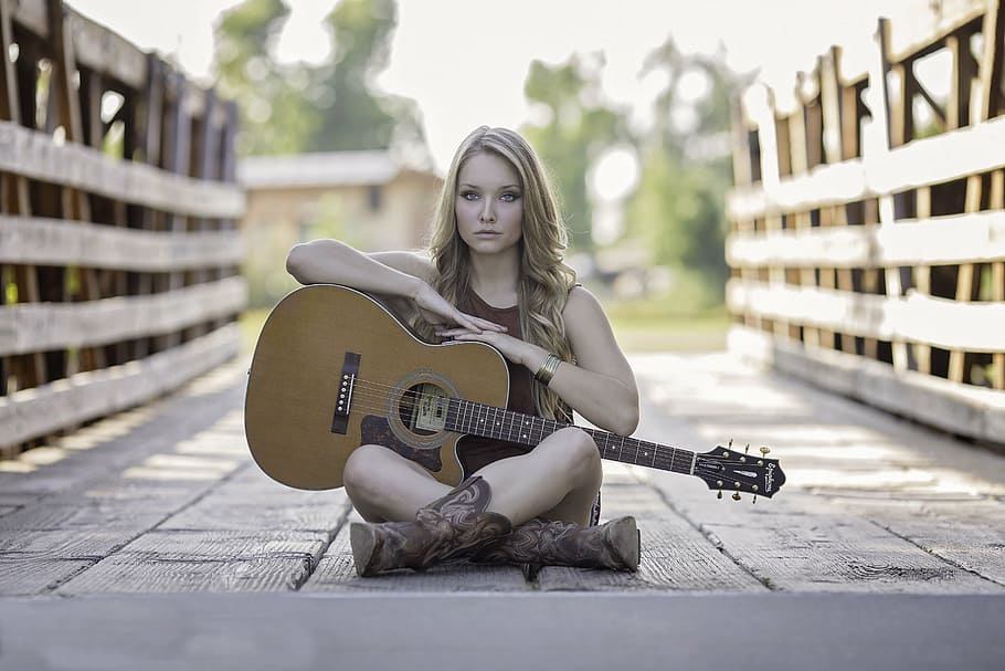 selective, focus photography, woman, wearing, sleeveless, top, holding, cutaway, acoustic, guitar