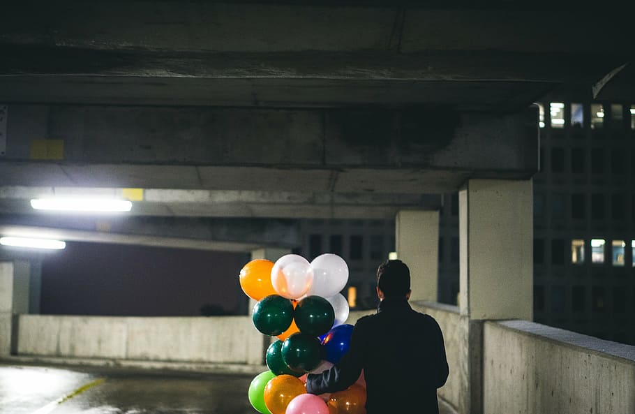 person, holding, assorted-color balloons, balloon, people, man, carpark, surprise, celebration, party
