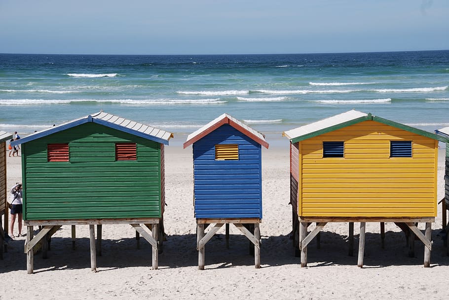 three, yellow, blue, green, shed, standing, shoreline, beach, cottages, water