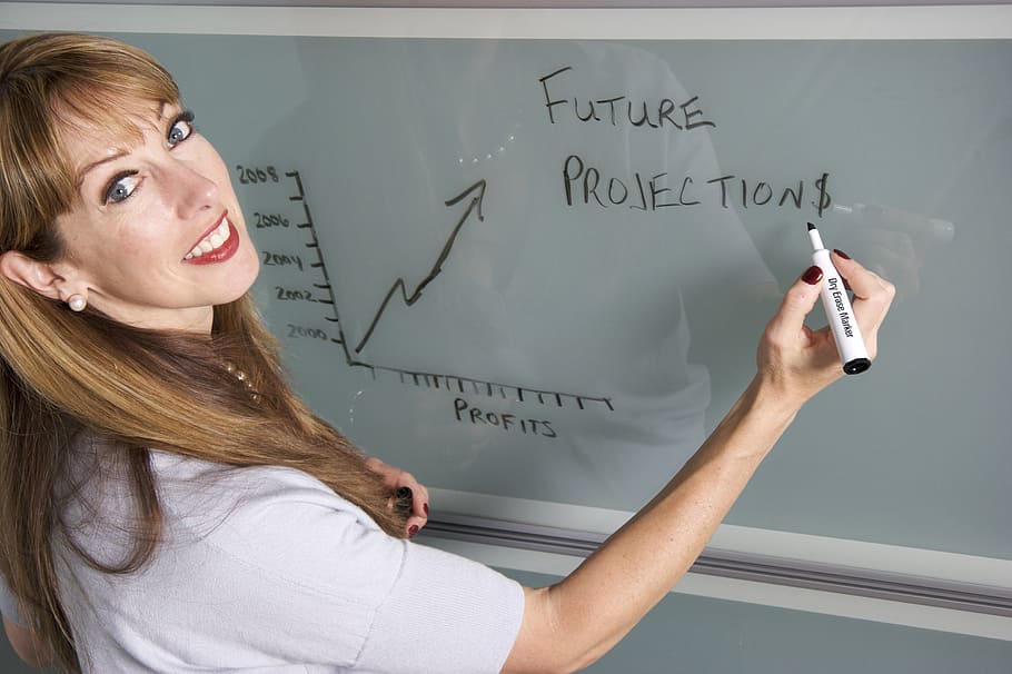 woman, writing, white, board, using, black, marker, smiling, teacher, female