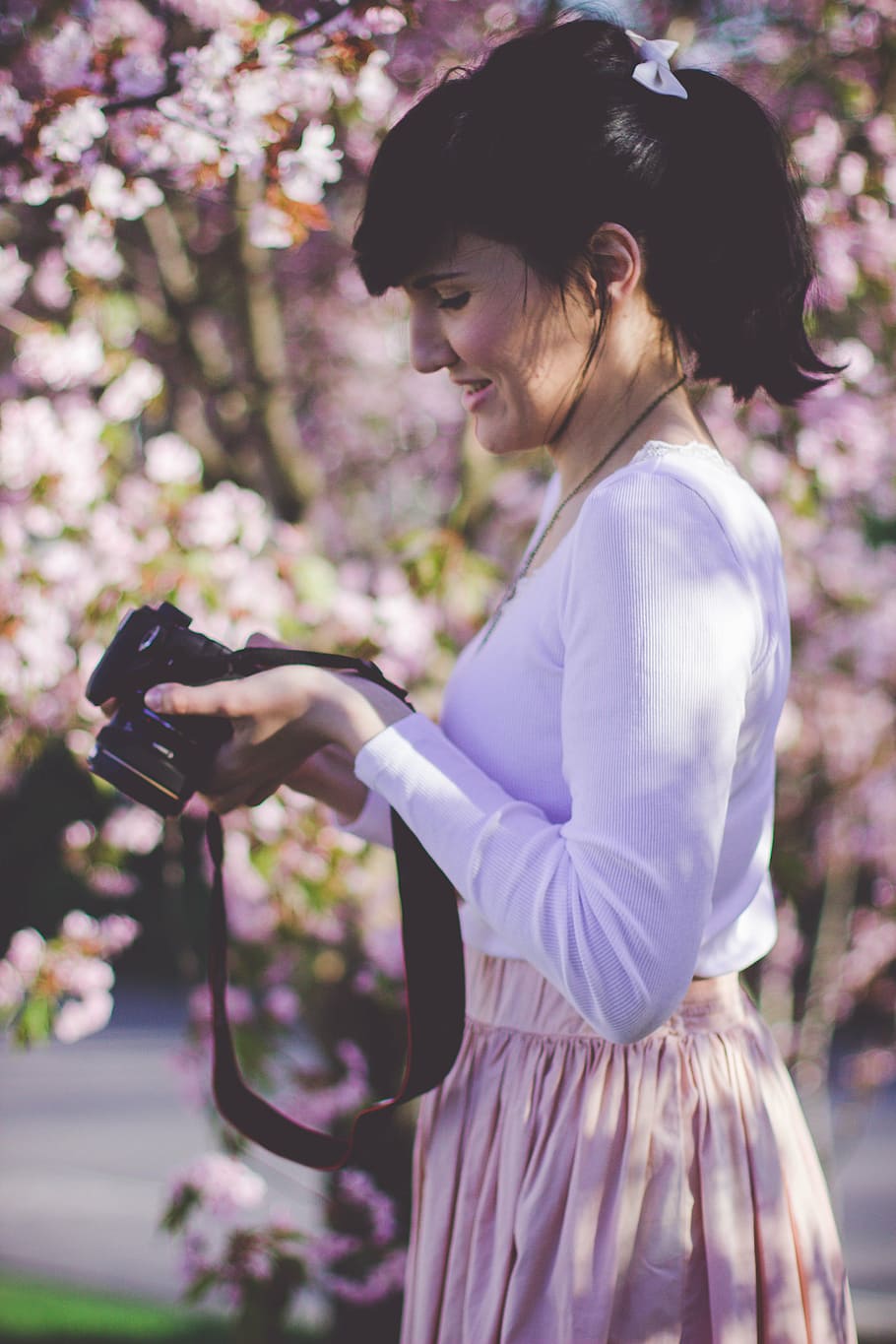 woman, holding, black, camera, surrounded, flowers, people, girl, alone, fashion