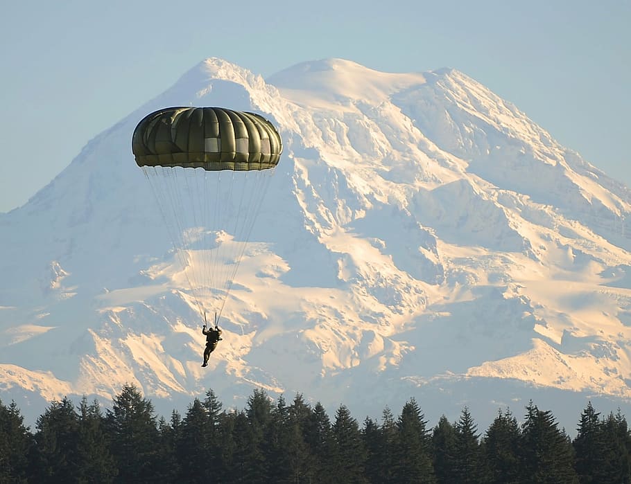 man, using, green, parachute, daytime, mountain alps, distance, paratrooper, parachutist, land