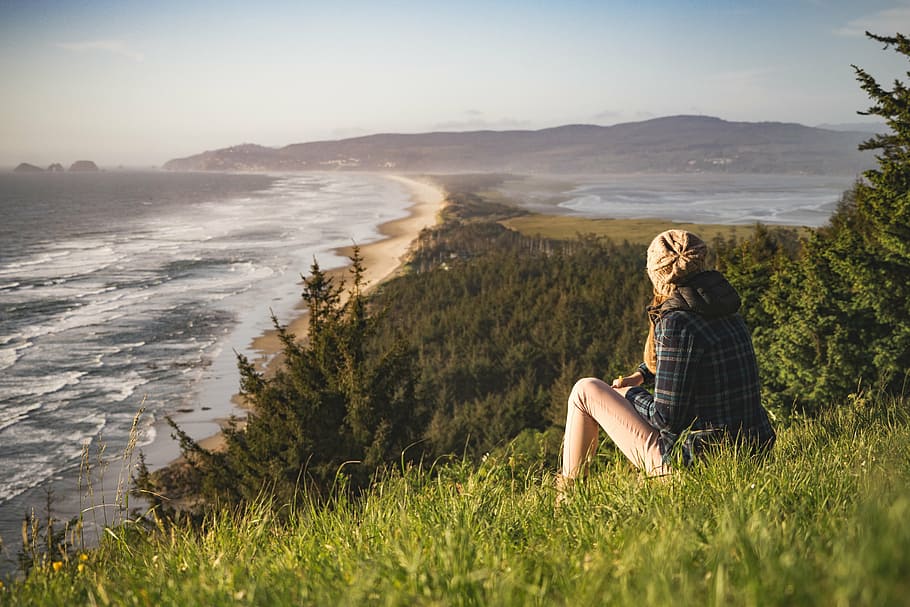 woman, sitting, green, grass, facing, body, water, beach, coast, nature