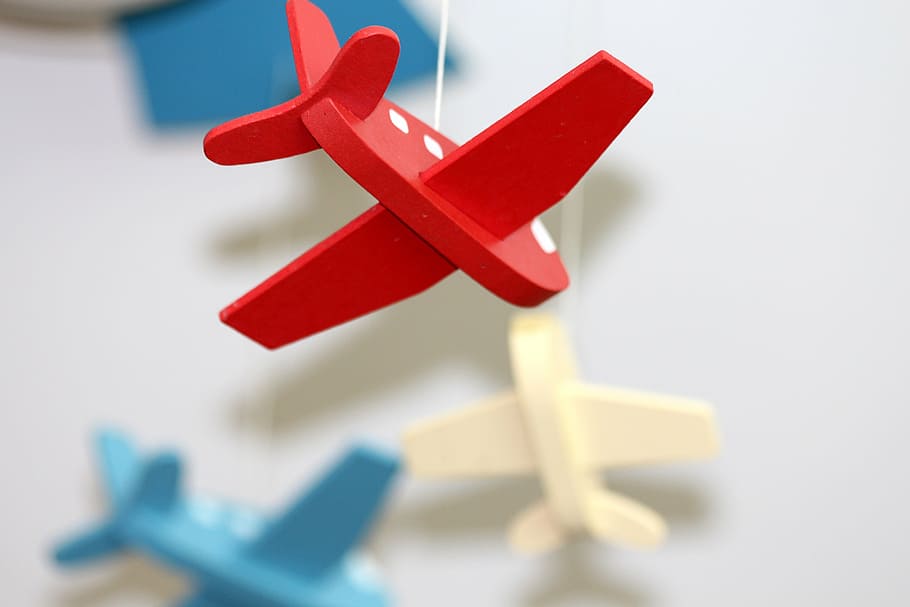 shallow, focus photography, red, wooden, airplane, hanging, decoration, plane, toys, light background