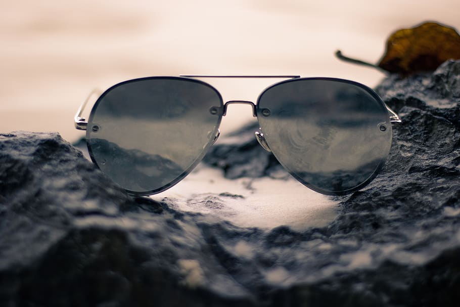 sunglasses, object, fashion, sunlight, glasses, nature, selective focus, close-up, reflection, sky
