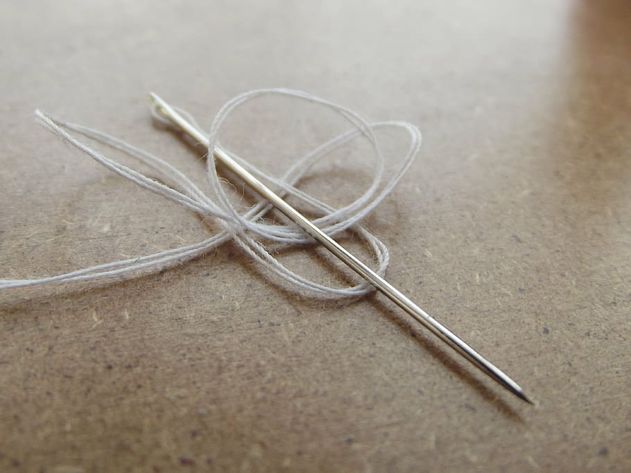 silver sewing pin, white, thread, needle, needles, sewing, clothing, yarn, close-up, indoors