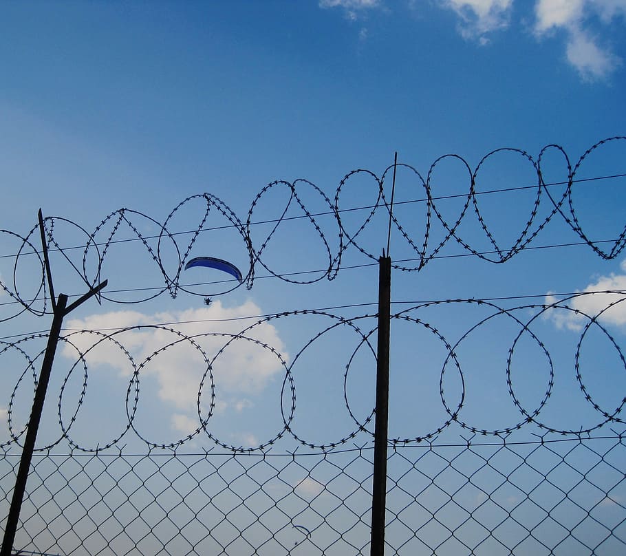 sky, blue, parachute, falling, gliding, drifting fence, barbed wire, white clouds, display, summer