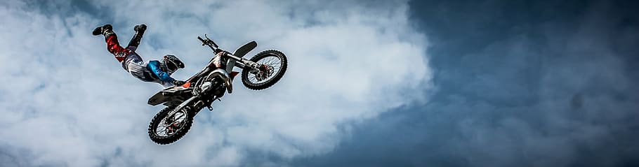 sports photography, motocross racer, holding, motocross dirt bike seat, suspended, air, biker, motorcycle, dirt, extreme