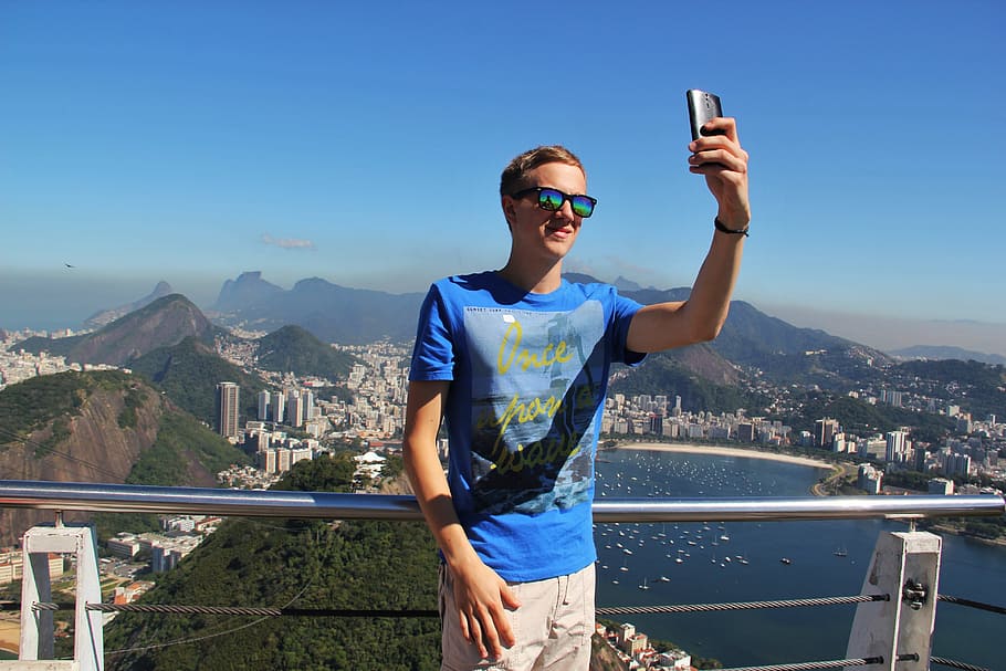 man, leaning, gray, steel railing, taking, daytime, Selfie, Rio De Janeiro, Sugarloaf, copacabana