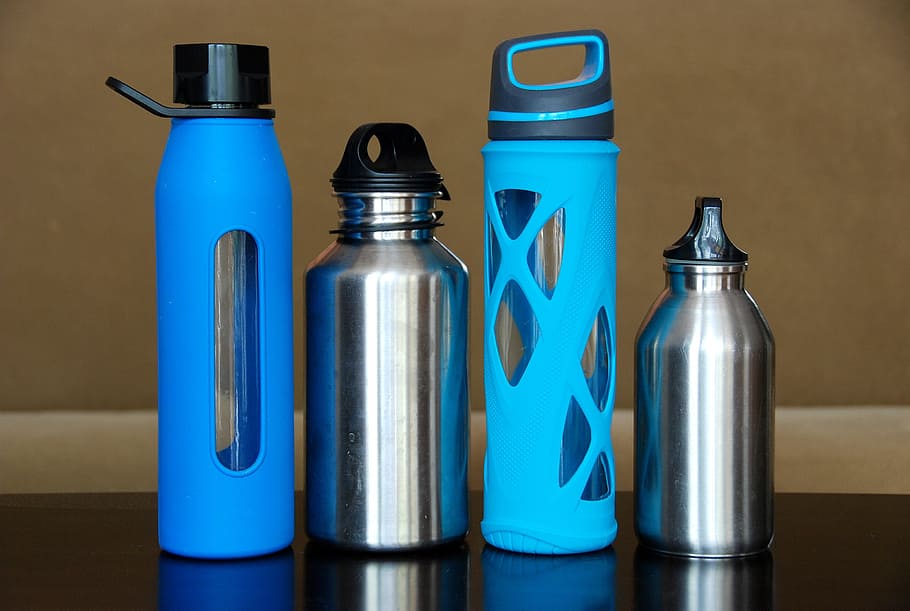 four, blue, gray, tumblers, black, wooden, surface, bottles, water, steel
