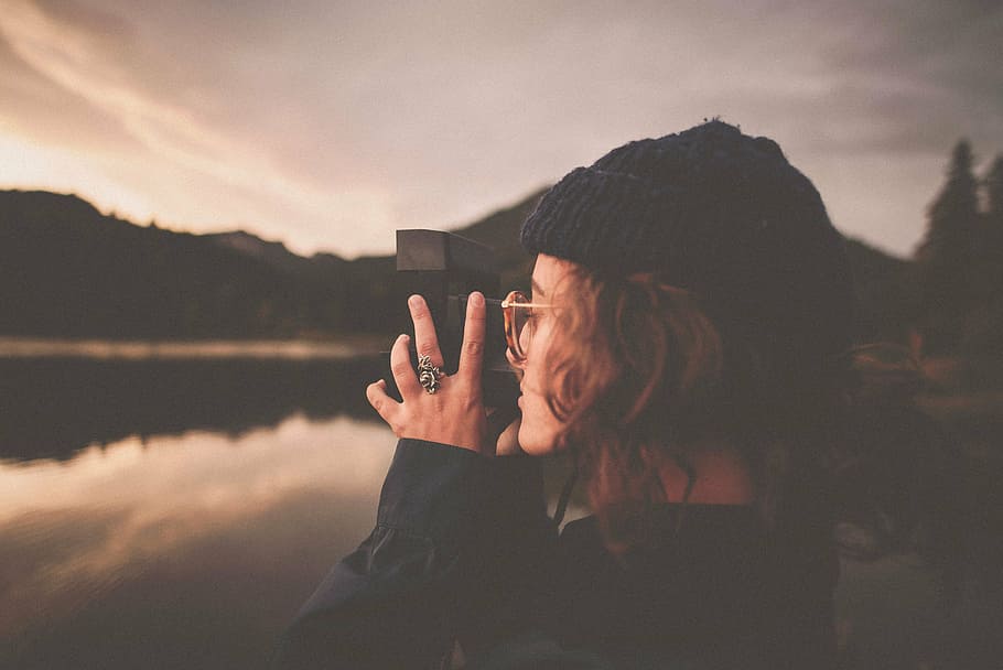 selective, focus, woman, holding, camera, taking, capturing, photograph, lake, people