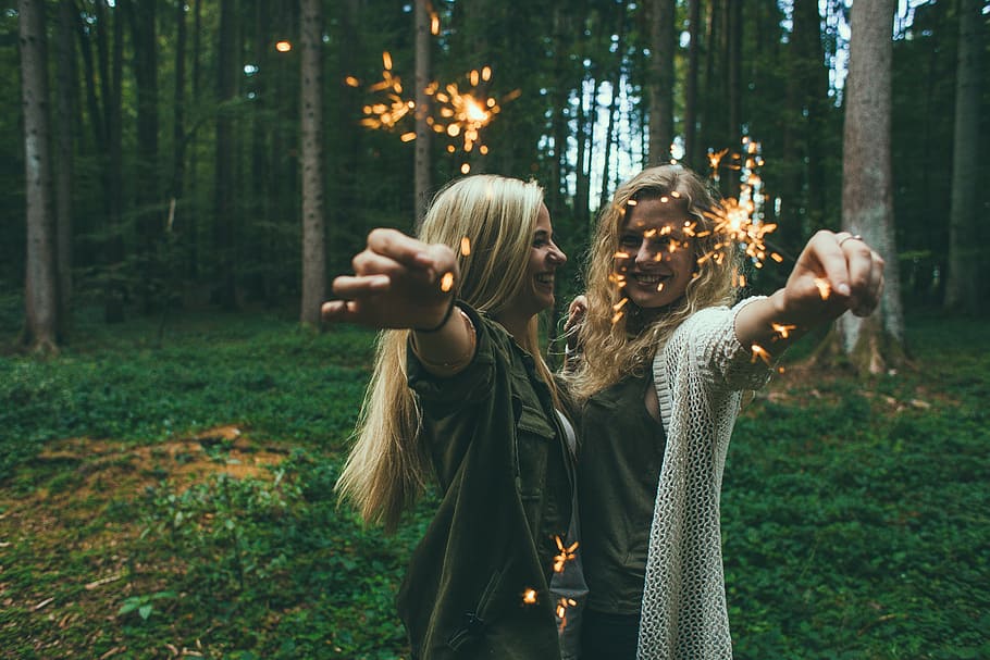two, blonde, hair woman, standing, forest, daytime, girls, sparklers, fireworks, celebration