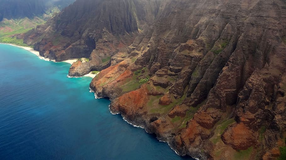 brown, rock mountain, body, water, daytime, napali coast, hawaii, kauai, ocean, helicopter view