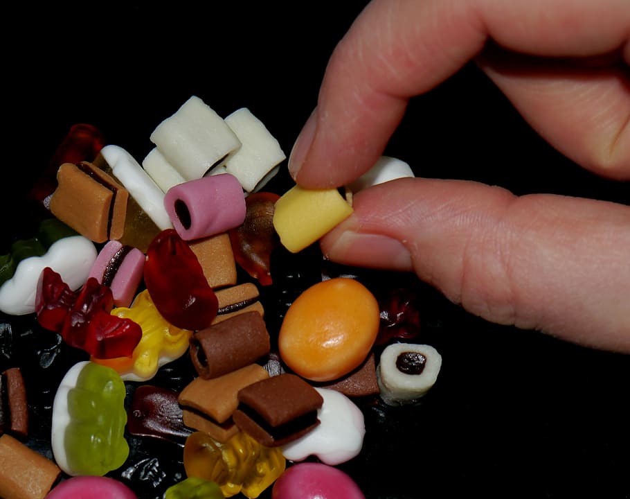 gummibärchen, rubber animals, finger hand, nibble, colorful, chewing gum, human hand, human body part, hand, one person