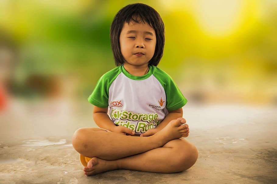 girl, wearing, white, green, crew-neck shirt, meditating, mediation, little girl, meditation, religion