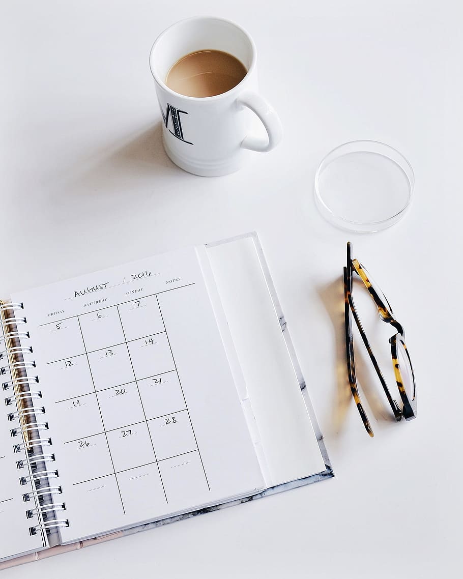 white, ceramic, mug, monthly, planner notebook, calendar, eyeglasses, plan, work, desk