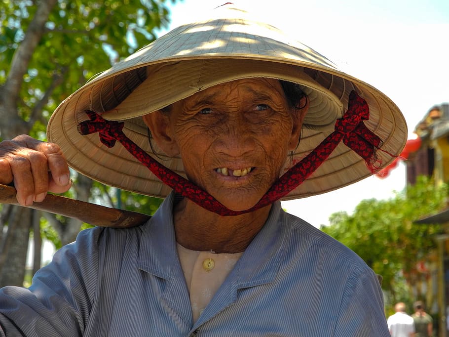 lady street vendor, hue, vietnam, one person, portrait, front view, headshot, hat, focus on foreground, clothing