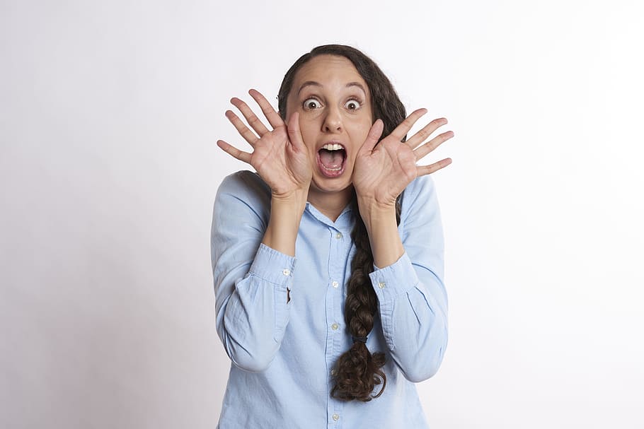 woman, wearing, blue, long-sleeved, button-up shirt, excited, surprised, happy, woman happy, young