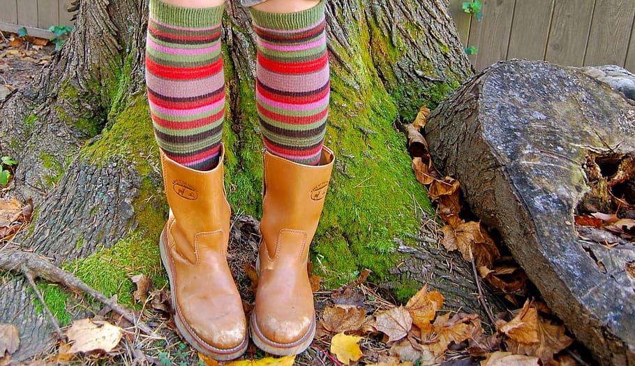 person, wearing, brown, leather cowboy boots, standing, tree, daytime, fun socks, boots, fall
