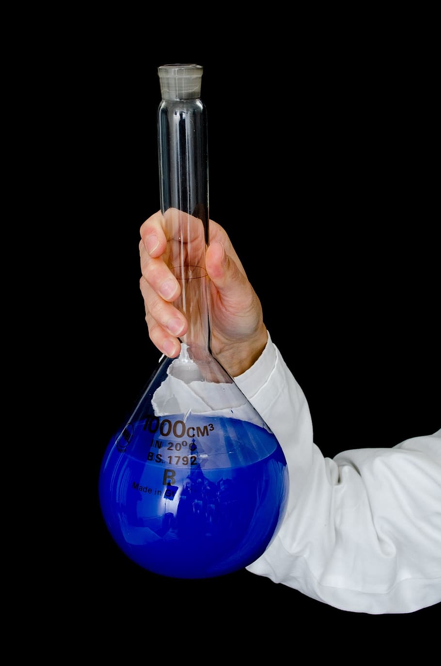 person, holding, filled, clear, glass tube, laboratory, lab, glass, liquid, blue