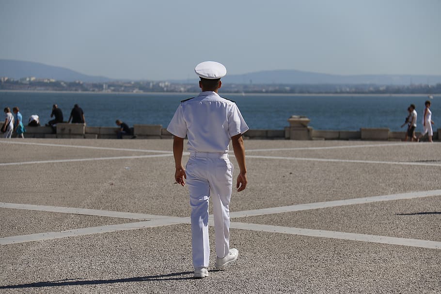 man, white, suit, hat, standing, gray, pavement, daytime, sailor, path