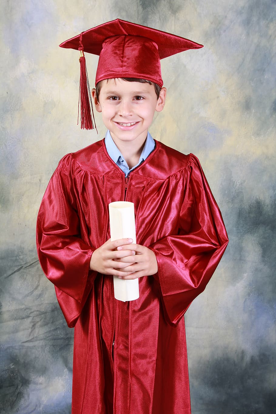 smiling, boy, wearing, red, academic, dress, holding, diploma, graduation, kindergarten graduation