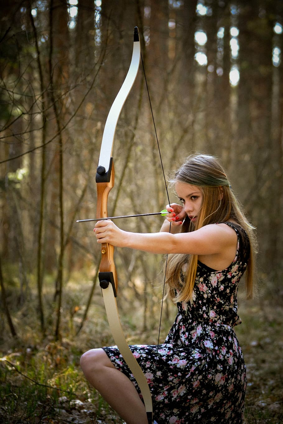 woman, black, floral, dress, holding, bow, arrow, kneeling, forest, lady