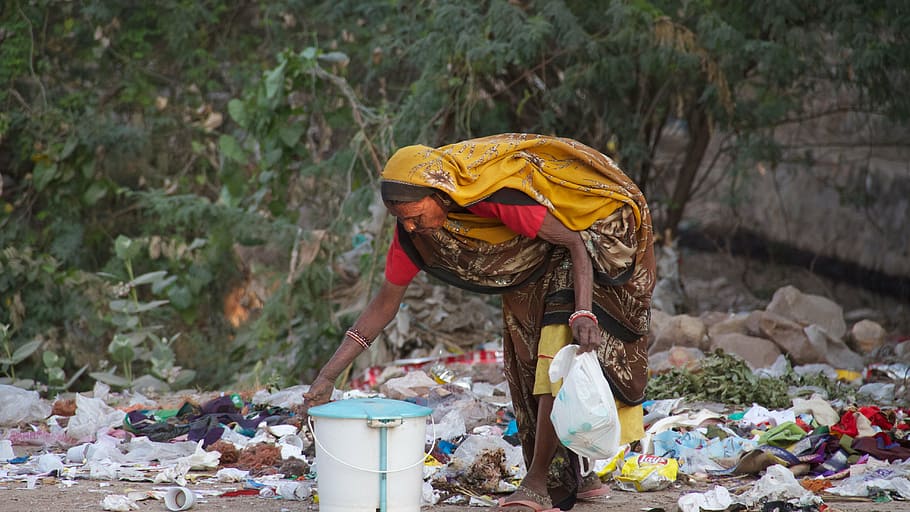 woman, bending, getting, white, blue, bucket, india, reuse, resources, woman looking in the garbage