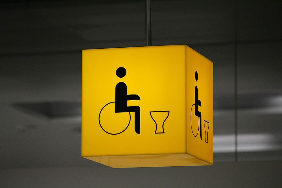 yellow hanging signage, disabled toilet, disability, wheelchair, wheelchair users, toilets, loo, note, yellow, sign