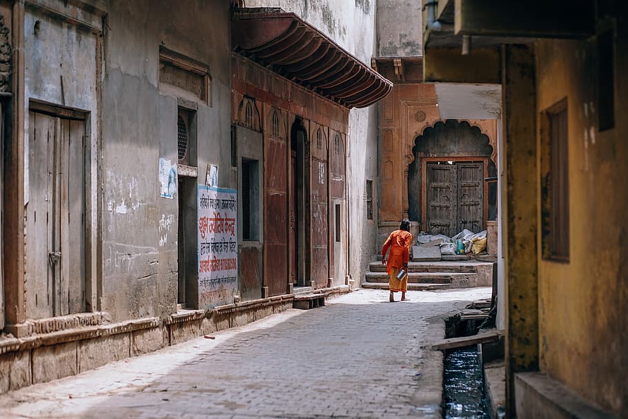 person, red, shirt, concrete, pavement, buildings, asia, bucket, carrying, colorful