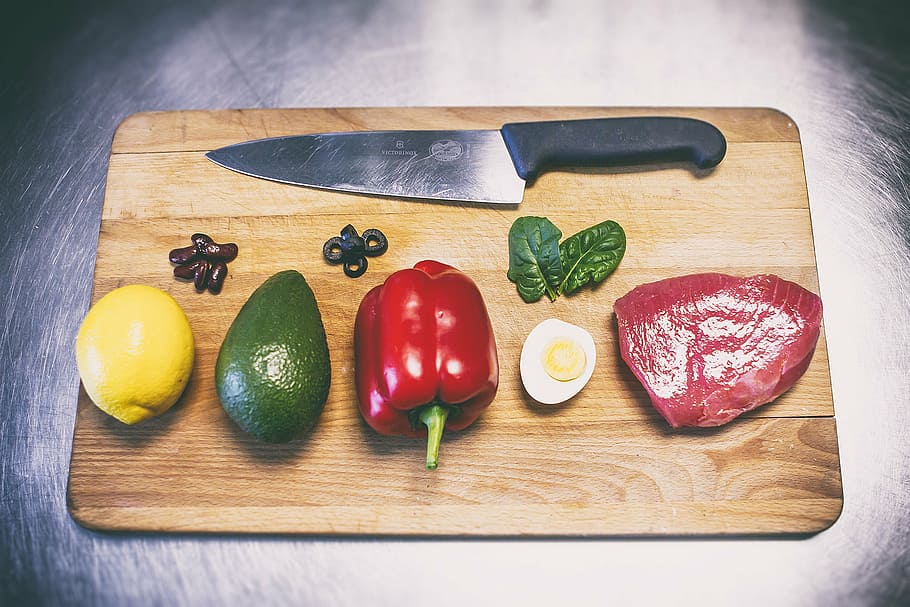 red, bell pepper, raw, meat, fruits, black, handled, knife, chopping, board