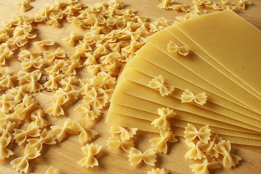 brown bow pastas, noodles, small, large, lasagna, raw, hard, spread, cook, grinding
