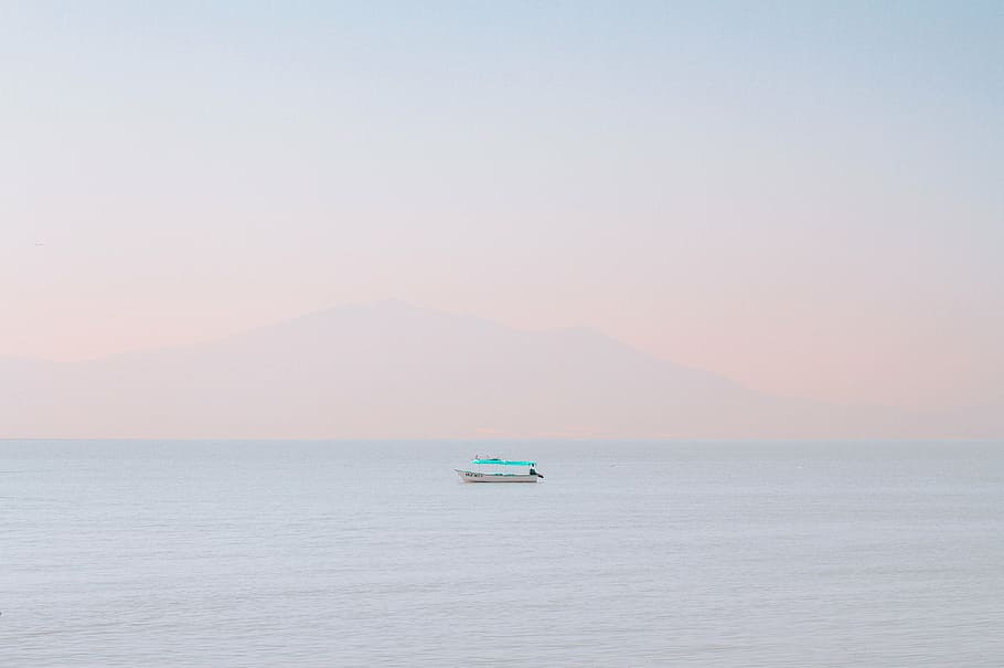 white, teal boat, middle, ocean, sea, water, horizon, blue, sky, cloud