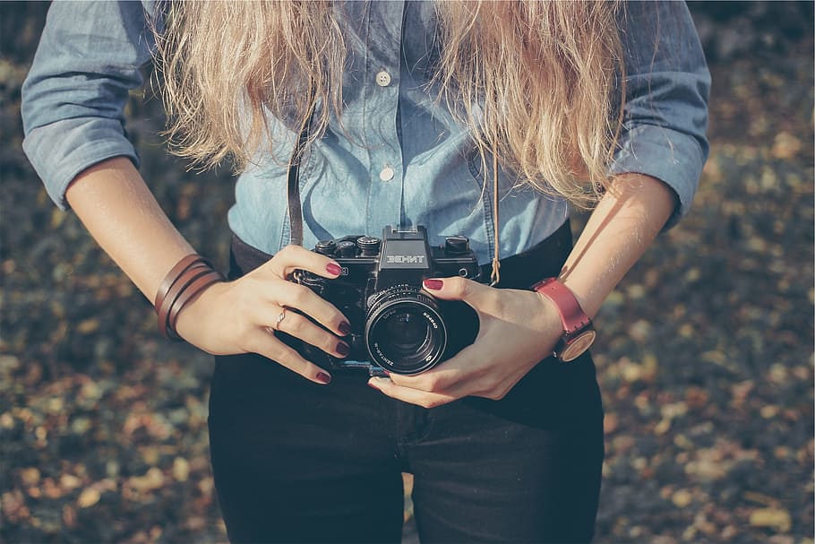 woman, holding, black, dslr camera, daytime, taking, photography, person, female, camera