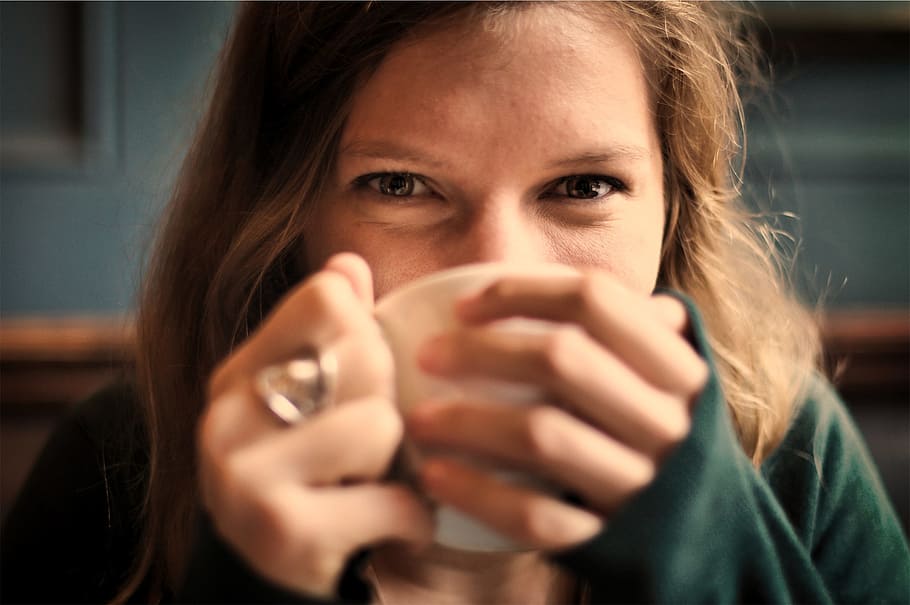 woman, wearing, green, sweater, sipping, white, ceramic, cup, girl, smile