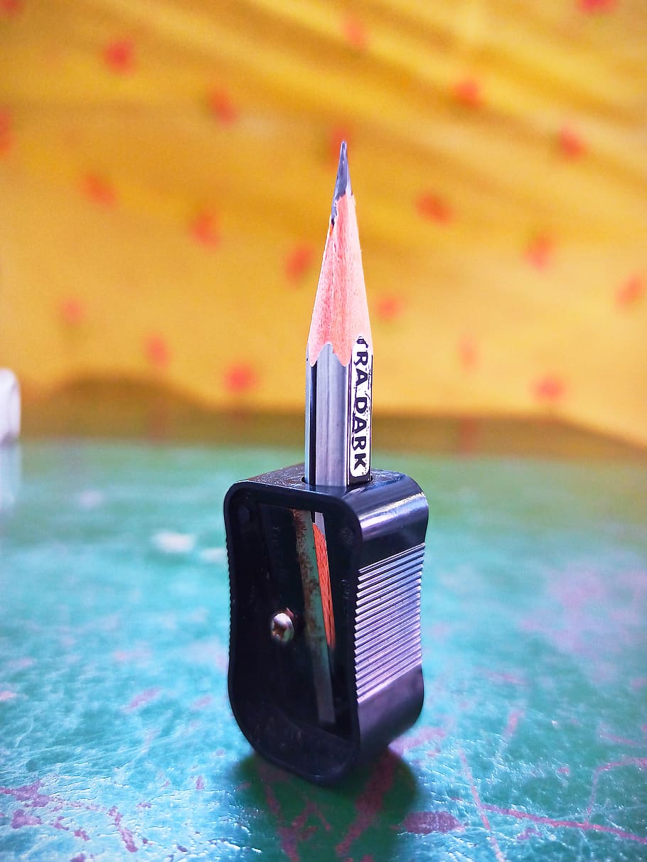pencil, black sharpener, stand, focus on foreground, close-up, indoors, still life, table, day, communication