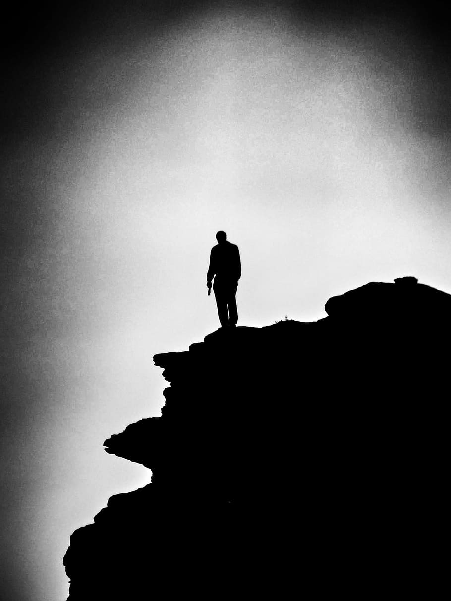 grayscale photo, man, top, mountain, loner, alone, rock, standing, black and white, b w