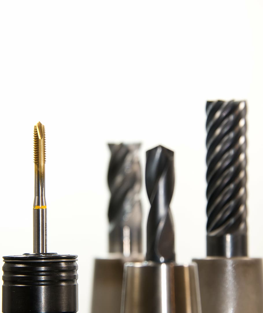 several drill bits, thread cutter, taps, drill, milling, milling machine, brass, golden, drilling, tool