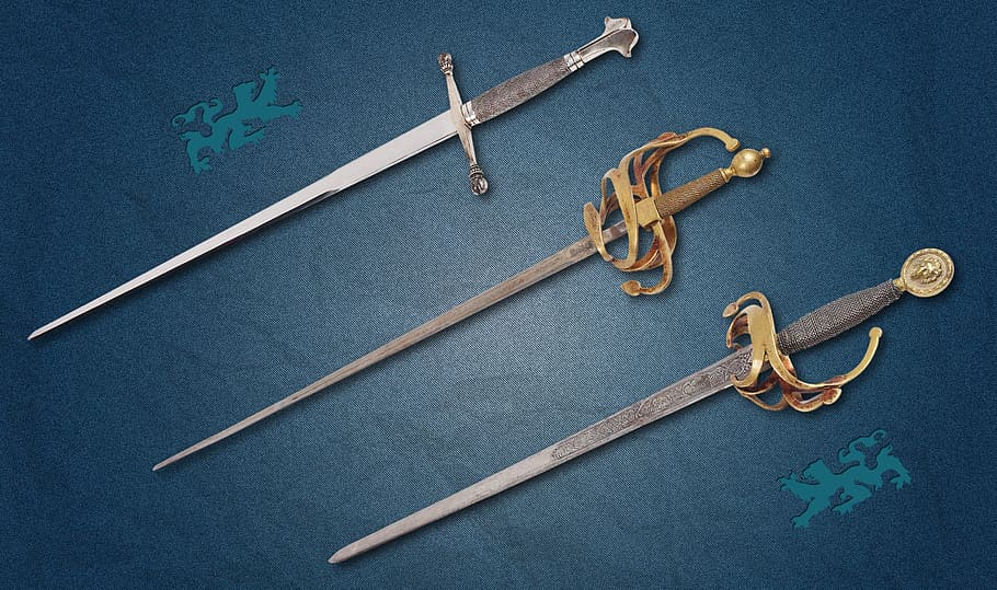 three assorted swords, sword, weapons, hilt, blade, blue, indoors, still life, studio shot, high angle view