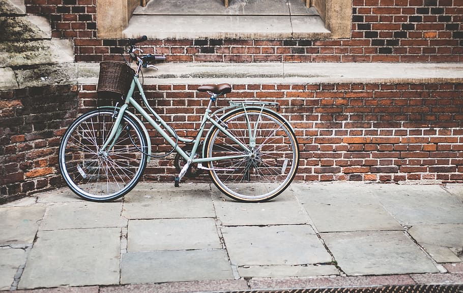 step-through bicycle, lean, parked, wall, bicycle, bike, brick wall, pavement, land vehicle, transportation