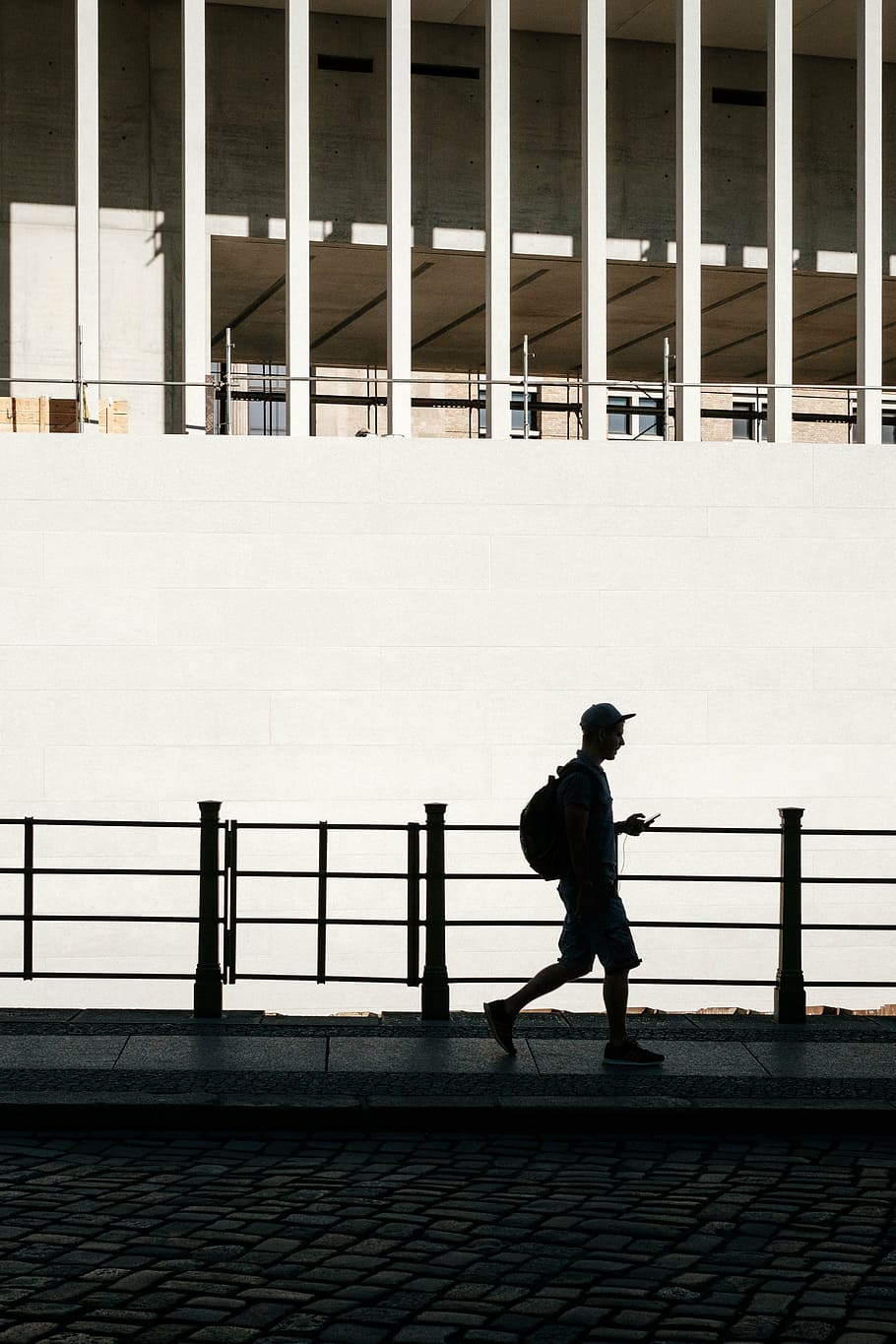 silhouette, man, walking, using, phone, architecture, building, infrastructure, street, outdoor